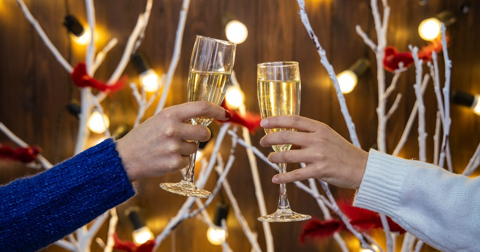 person holding wine glasses with red liquid